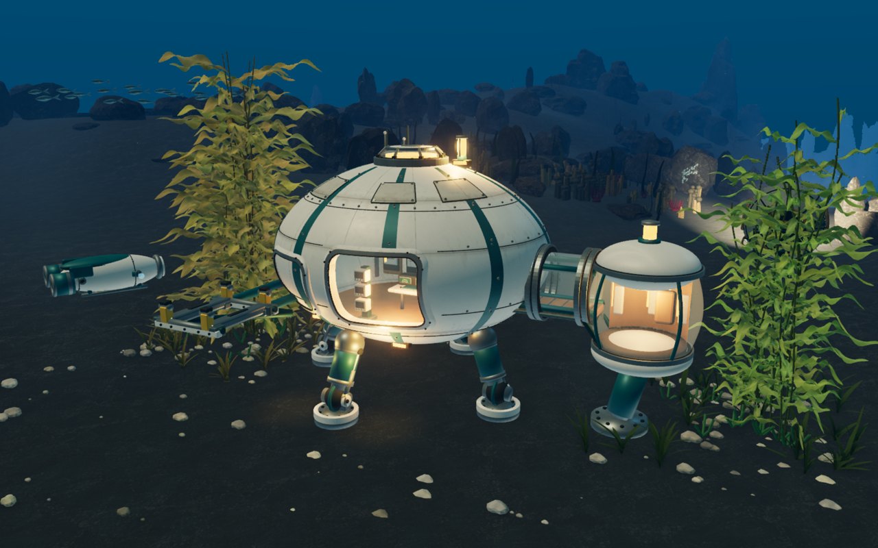 The Pelagic observatory on the seabed, its lit rooms glowing behind glass among the kelp